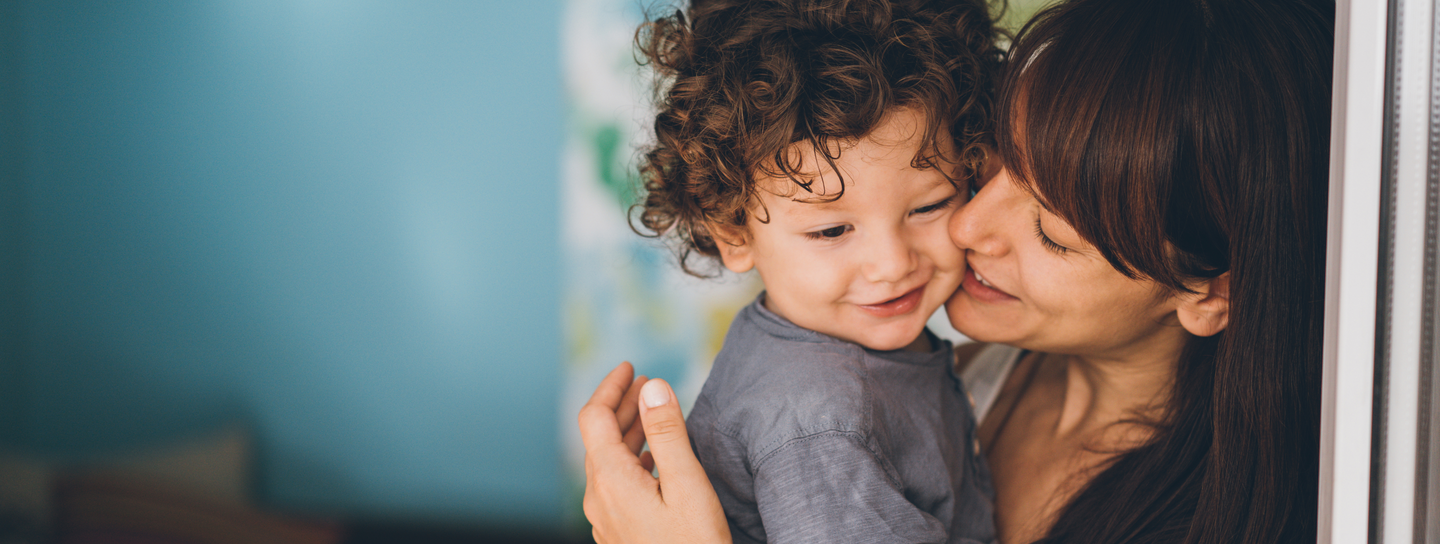 Mom kissing her son on cheek