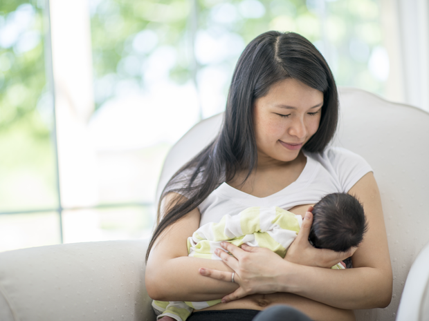 Baby feeding at mother's breast.