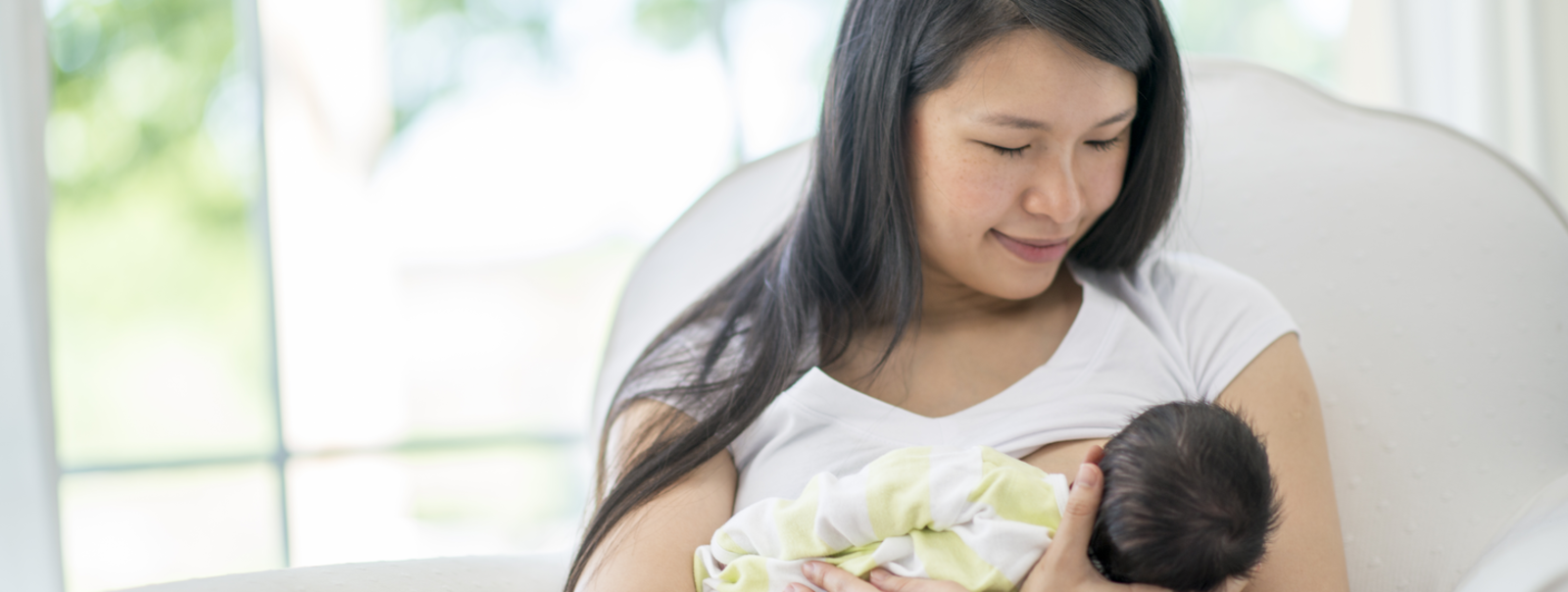Baby feeding at mother's breast.