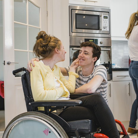 Teenage boy with his disabled sister who is in a wheelchair
