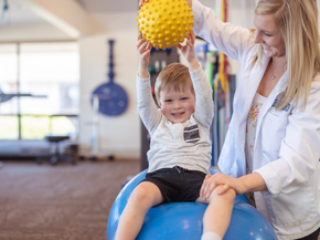 Young boy in physical therapy with provider