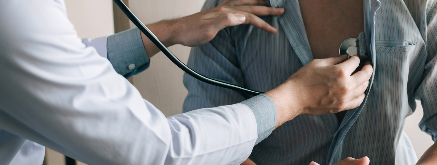 A doctor uses a stethoscope to listen to a patient's lungs