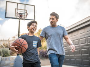 Father and son playing basketball