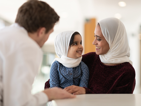 Doctor speaking with mother and child.