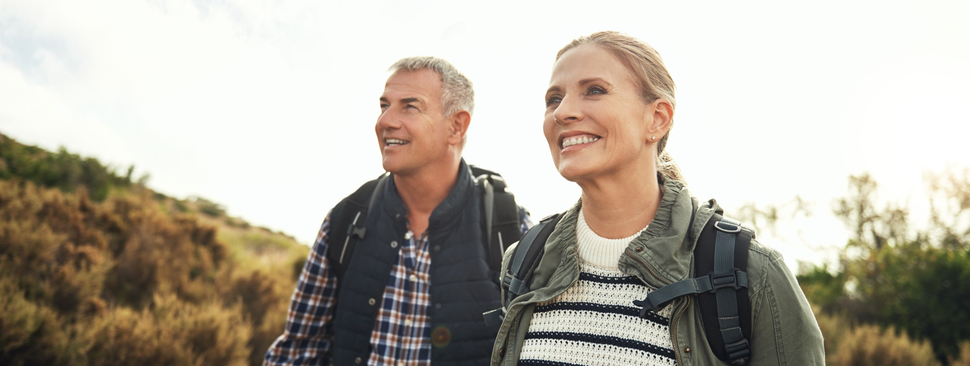 Woman and man on outdoor hike smiling