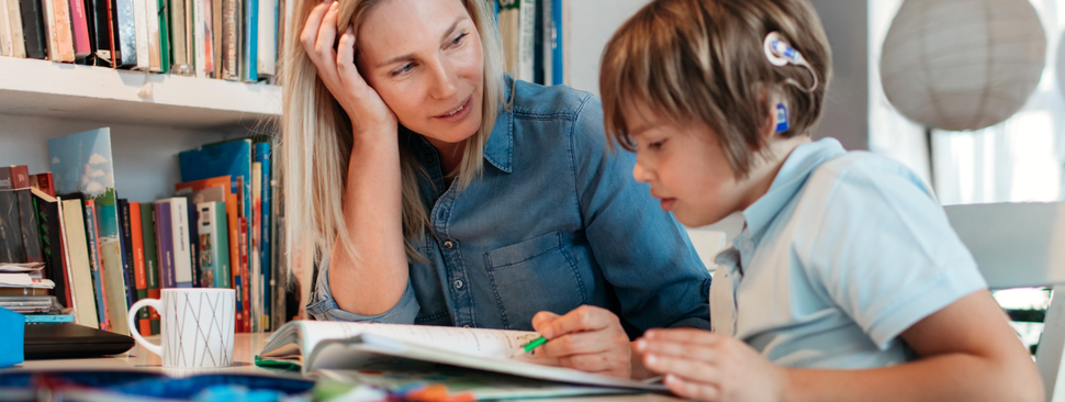 A doctor fits a girl for cochlear implants