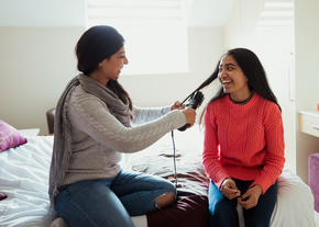 A mother does her daughter's hair