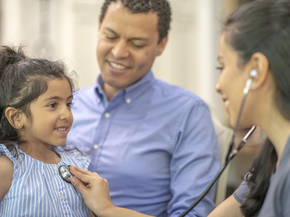 young hispanic family with nurse in rural clinic