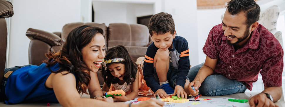 Latino family enjoying being together at home and playing with kids