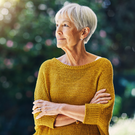 Woman looking away in yellow sweater.