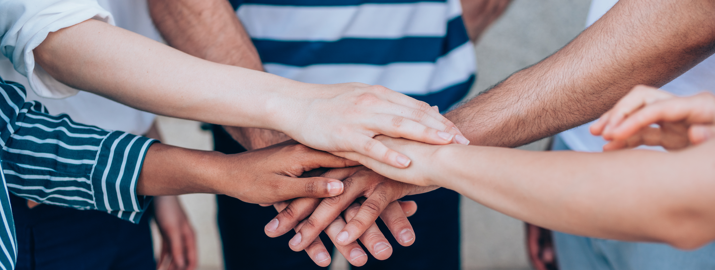 stack of hands, friends showing unity