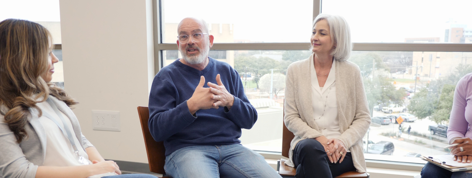 A support group with a man talking