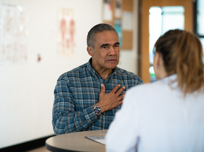 Mature man speaks with a member of his care team