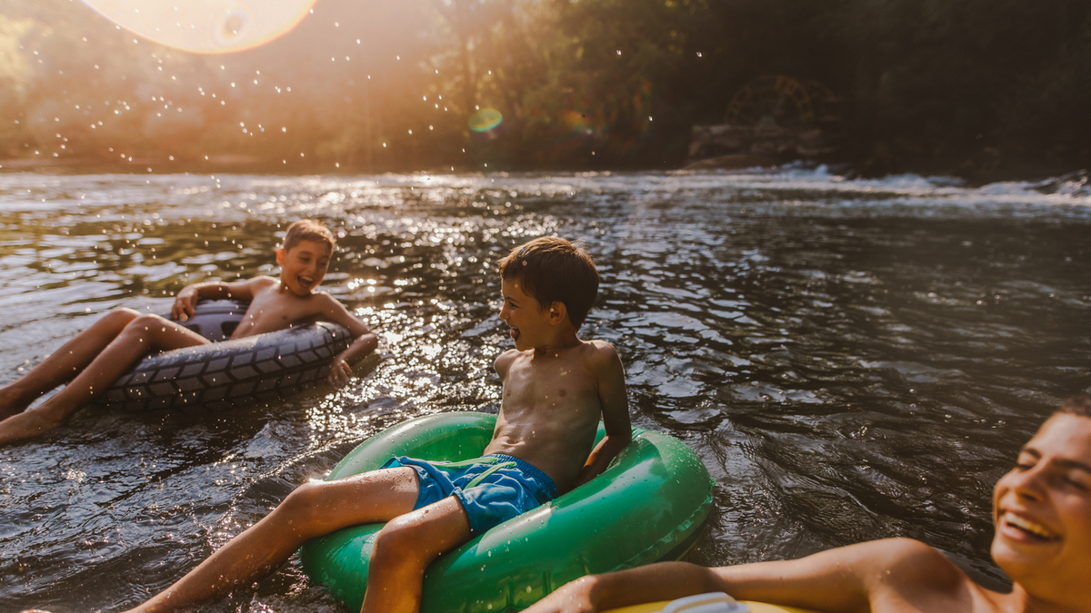 Boys floating in the river on tubes on a summer afternoon.