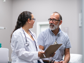 Woman smiles while speaking to provider in hospital