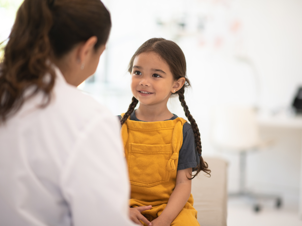 Young girl speaking with a health care provider