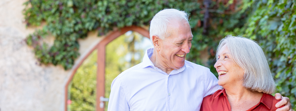 mature couple smiling outside