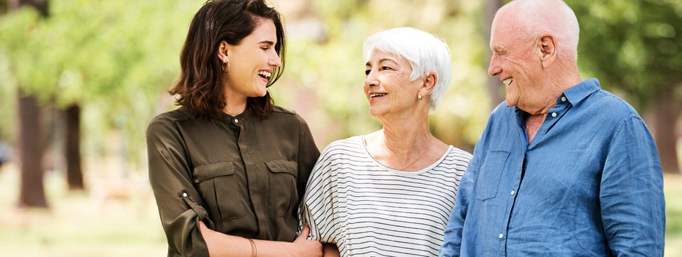Parents with adult daughter walking outside
