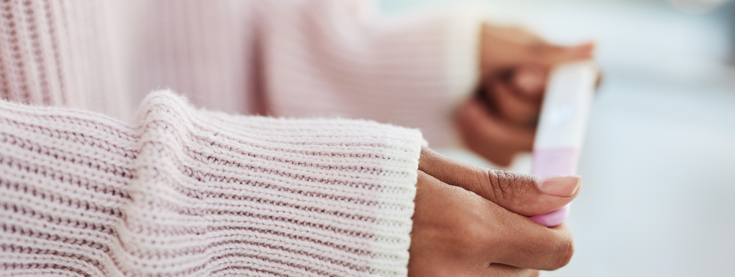 woman holds a pregnancy test