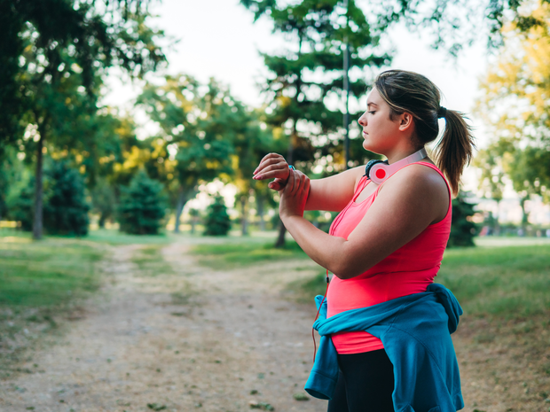 Woman runner checking her smart watch