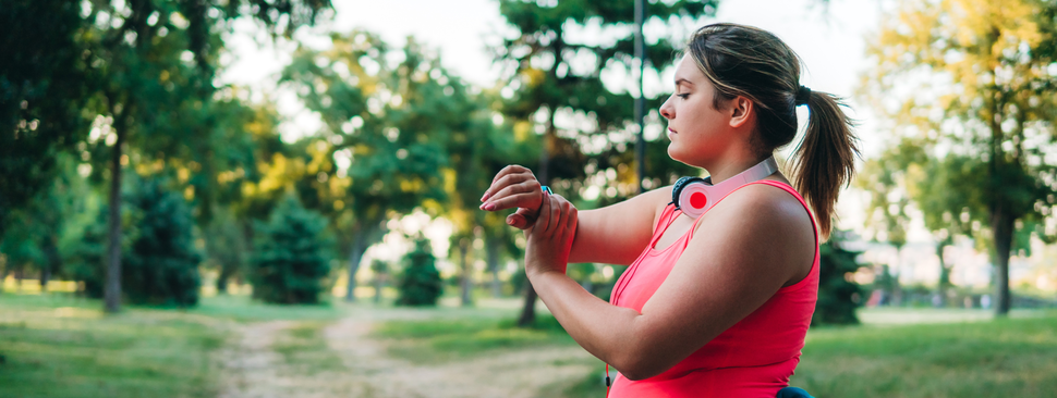 Woman runner checking her smart watch