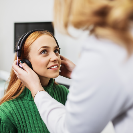 Young woman at medical examination in audiology office