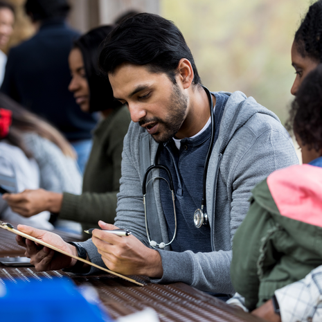 Doctor helps community member and her small child