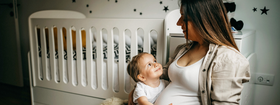pregnant woman and her daughter get ready for a new baby