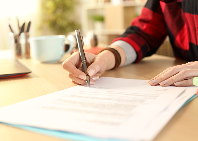 Person writing on paper.