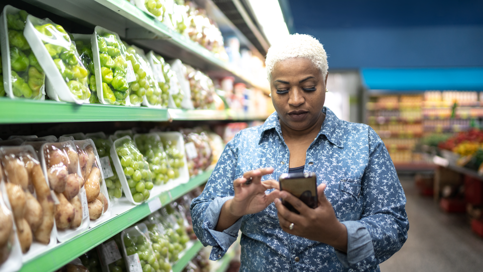 Woman on her phone in the grocery store