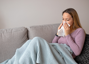 A woman blows her nose