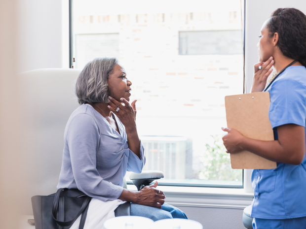 Patient and nurse in clinic office