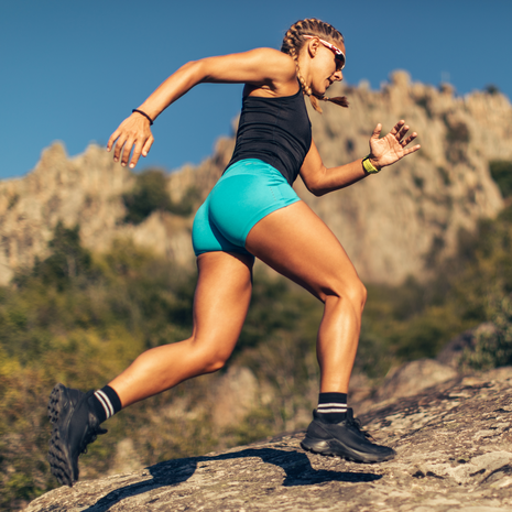 Woman running on an extreme trail