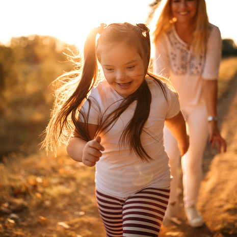 Smiling girl running down the road.