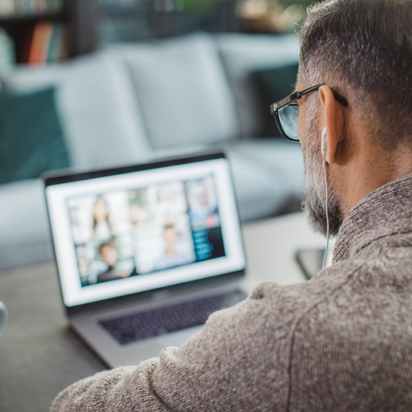 Man uses laptop for a meeting