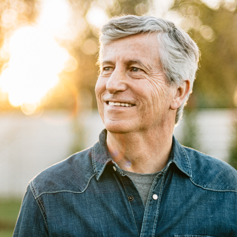 Senior man smiling at sunset