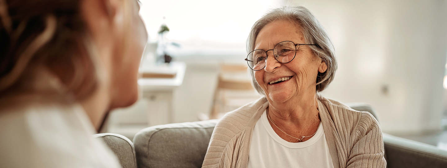 Young woman comforting elderly woman.