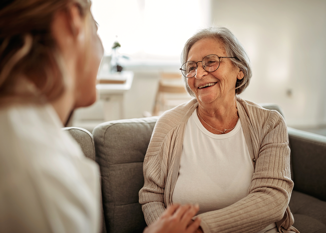 Elderly woman speaking with younger woman
