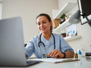 Nurse works on a laptop