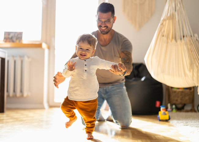 Proud father and walking son