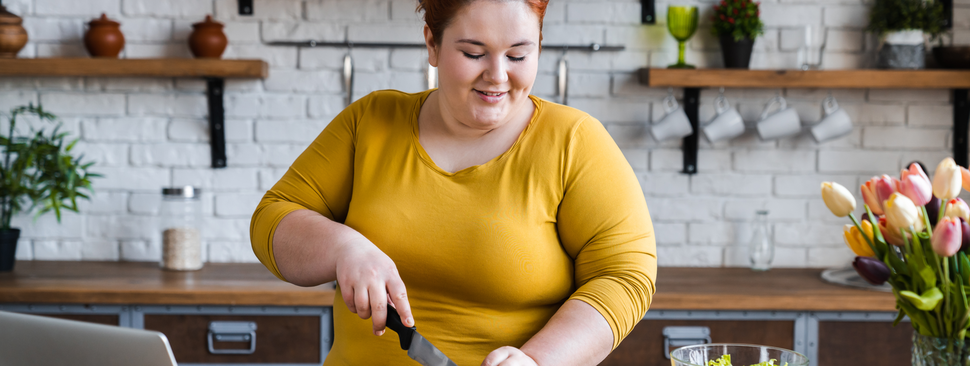 Woman in kitchen wearing a yellow shirt 