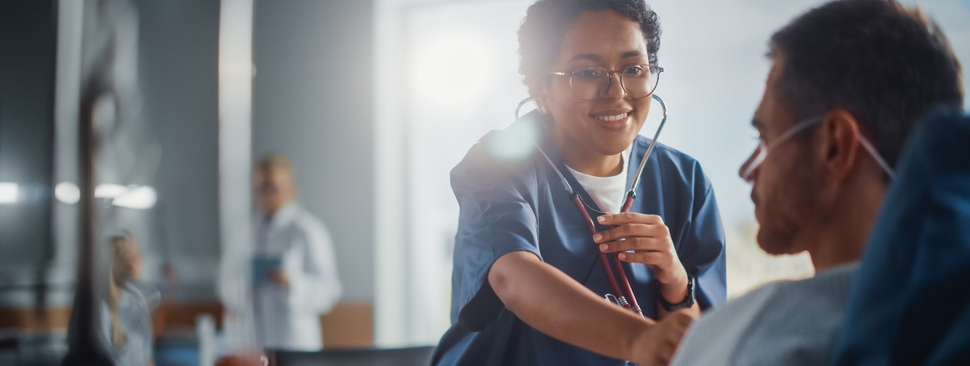 nurse checks on a patient in the hospital