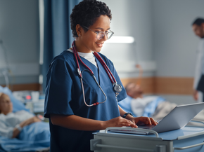 Two nurse assisting patient