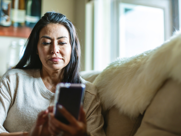 Woman reviews her appointment results, post-visit.