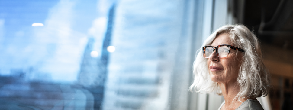 Person gazing out large window.