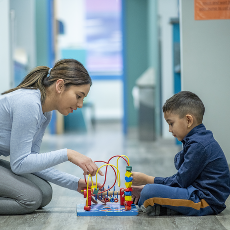 Female occupational therapist and young boy patient