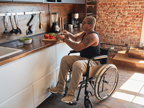 Person in wheelchair cooking at home