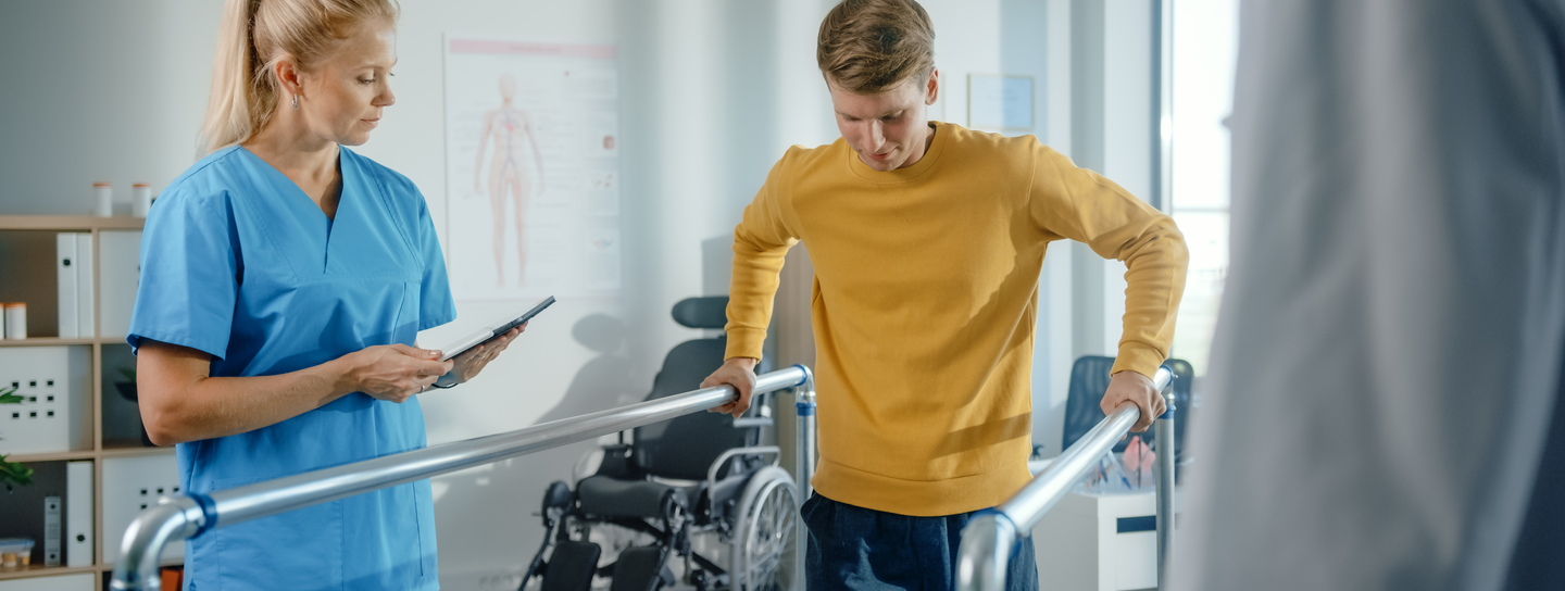 Determined Male Patient with Injury Successfully Walks His First Steps