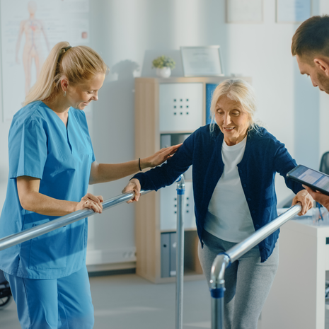 Female patient walking with assistance