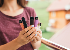 Person holding vapes